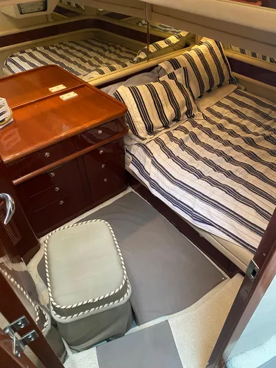  Yacht Photos Pics 2002 Sea Ray 56 Sedan Bridge cabin with striped bedding and wooden cabinetry.