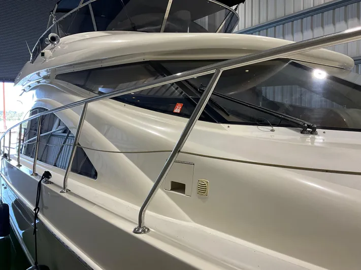  Yacht Photos Pics 2007 Ocean Alexander 54V yacht, sleek design, docked indoors, side view.