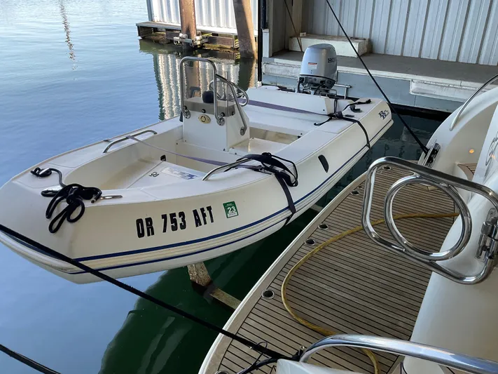  Yacht Photos Pics Small white boat docked beside Ocean Alexander 54V yacht, 2007 model, in a marina.