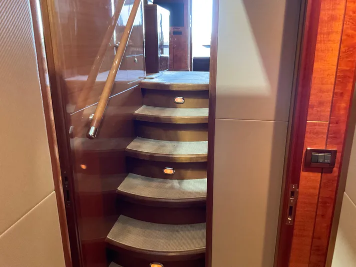 Yacht Photos Pics Staircase inside 2007 Ocean Alexander 54V yacht with wooden handrail and carpeted steps.