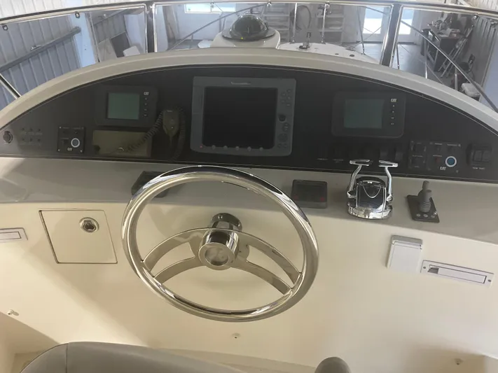  Yacht Photos Pics Helm of 2007 Ocean Alexander 54V yacht with steering wheel and navigation controls.