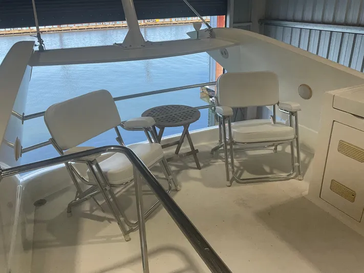  Yacht Photos Pics 2007 Ocean Alexander 54V yacht deck with chairs and table, overlooking water.