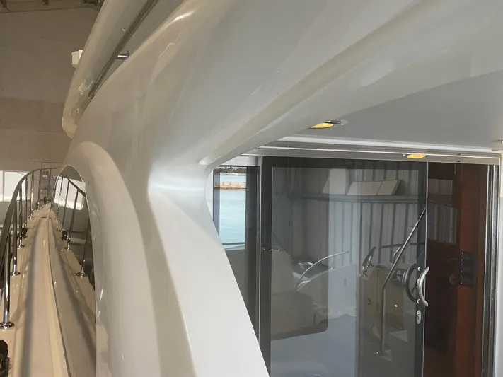  Yacht Photos Pics 2007 Ocean Alexander 54V yacht, sleek exterior design with glass doors and railing.