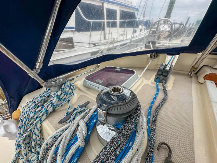 Three Dolphins Yacht Photos Pics 2005 Island Packet 370 sailboat deck with ropes and winch in marina setting.