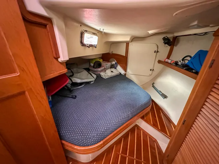 Three Dolphins Yacht Photos Pics Cozy cabin interior of 2005 Island Packet 370 sailboat with wooden accents and storage.