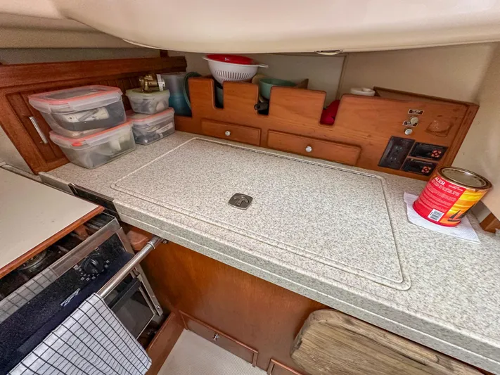 Three Dolphins Yacht Photos Pics Interior of 2005 Island Packet 370 sailboat kitchen with storage and countertop.