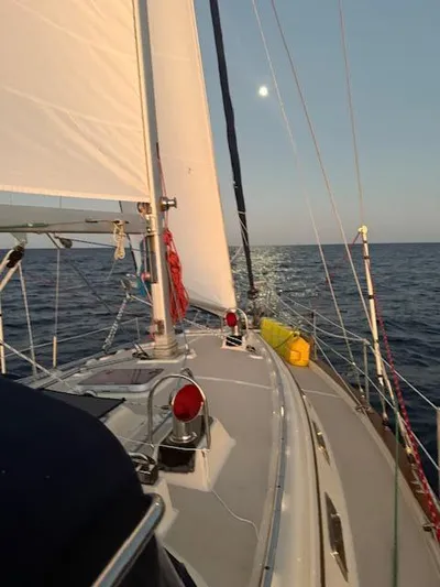 Three Dolphins Yacht Photos Pics Sailing on a 2005 Island Packet 370 yacht under clear skies.