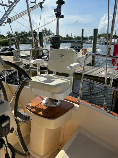 Three Dolphins Yacht Photos Pics Captain's chair on 2005 Island Packet 370 sailboat, docked at marina.