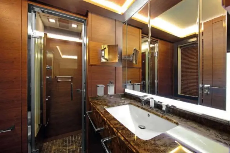  Yacht Photos Pics Luxurious bathroom interior on 2011 Benetti Delfino 93 yacht, featuring elegant wood and marble finishes.