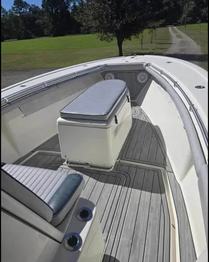  Yacht Photos Pics 2011 Yellowfin 29 Offshore boat with spacious deck and seating, set against a scenic backdrop.