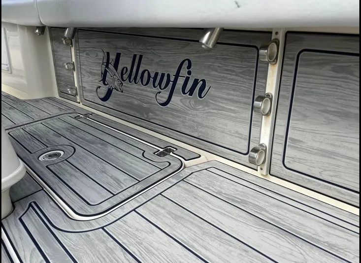 Yacht Photos Pics 2011 Yellowfin 29 Offshore boat deck with wood-like finish and logo.