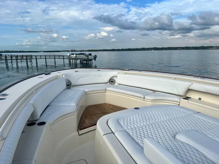  Yacht Photos Pics Luxurious 2020 Scout 420 LXF boat with elegant seating, docked by serene waters.