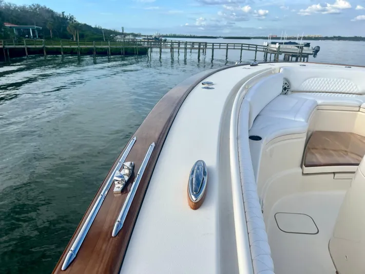  Yacht Photos Pics 2020 Scout 420 LXF boat with luxurious seating, docked by a serene waterfront.