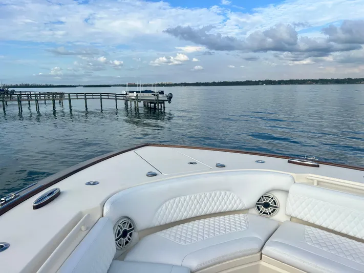  Yacht Photos Pics 2020 Scout 420 LXF boat on calm water with scenic dock view.