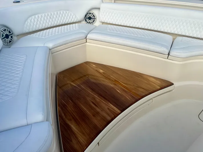  Yacht Photos Pics Luxurious seating area on 2020 Scout 420 LXF boat with white cushions and wood accents.