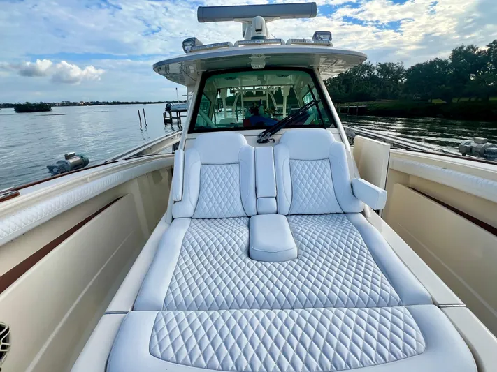  Yacht Photos Pics 2020 Scout 420 LXF luxury boat with plush seating on a serene water backdrop.