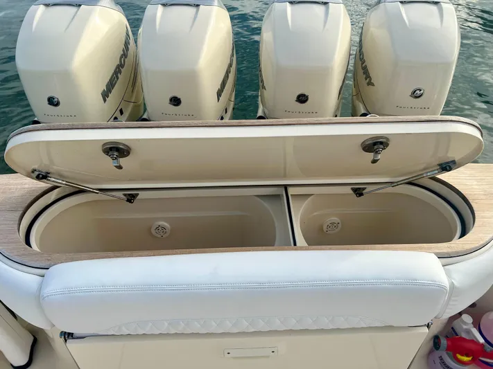  Yacht Photos Pics 2020 Scout 420 LXF boat with four Mercury engines and open storage compartments.