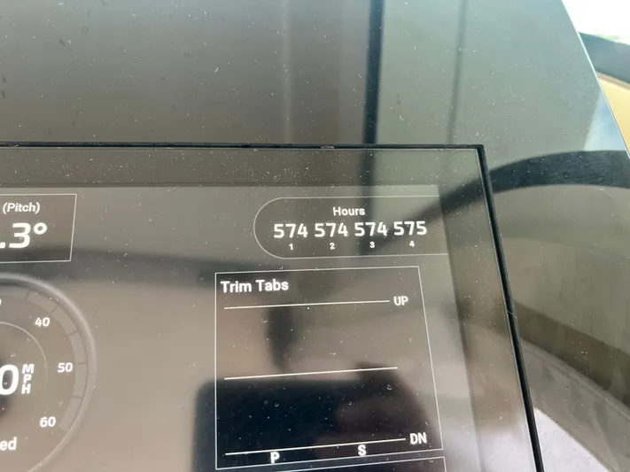  Yacht Photos Pics Dashboard display of 2020 Scout 420 LXF showing engine hours and trim tab settings.
