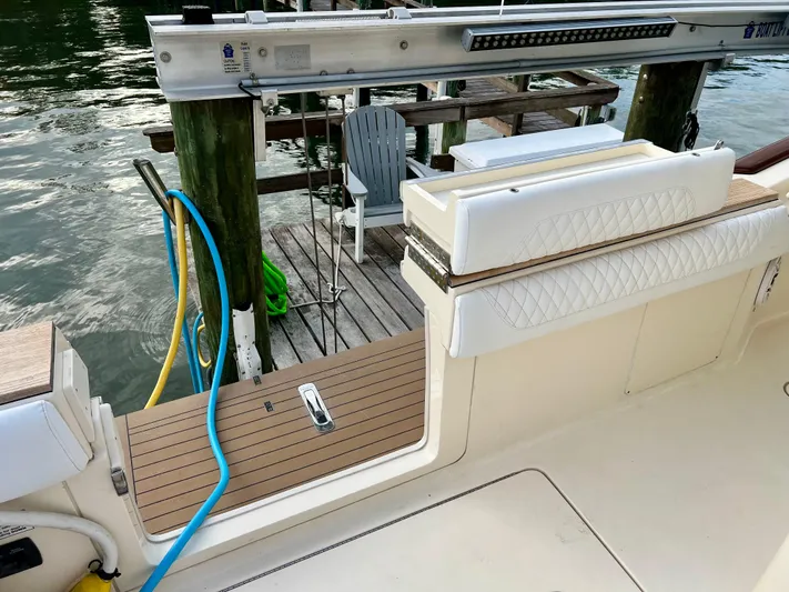  Yacht Photos Pics 2020 Scout 420 LXF boat docked, featuring a clean deck and seating area.