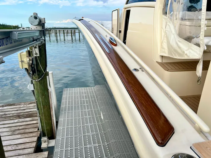  Yacht Photos Pics 2020 Scout 420 LXF yacht docked, featuring sleek design and wooden accents.