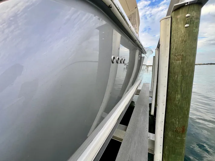  Yacht Photos Pics 2020 Scout 420 LXF boat docked, side view with water and sky background.