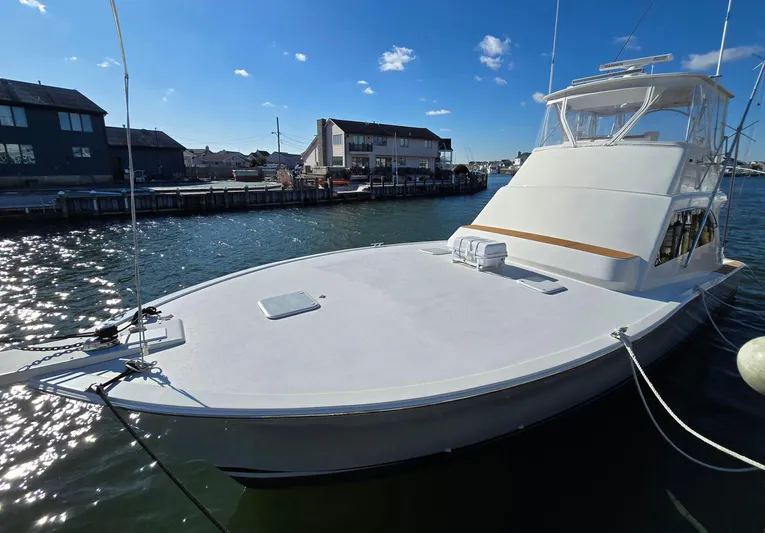  Yacht Photos Pics 2000 Post 47 Convertible yacht docked in a marina under a clear blue sky.