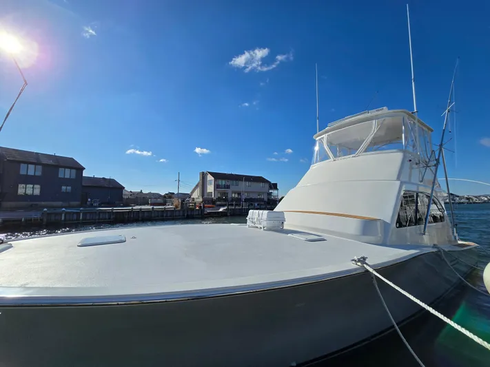 Yacht Photos Pics 2000 Post 47 Convertible yacht docked under clear blue sky.