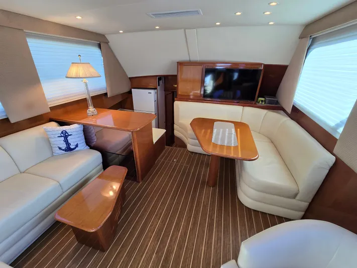  Yacht Photos Pics Luxurious interior of a 2000 Post 47 Convertible yacht with elegant seating and wooden accents.