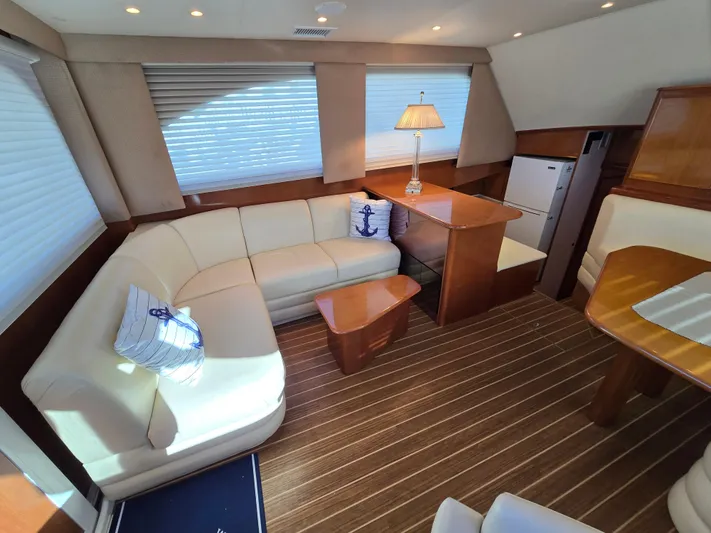 Yacht Photos Pics Luxurious interior of a 2000 Post 47 Convertible yacht with elegant seating and wooden accents.