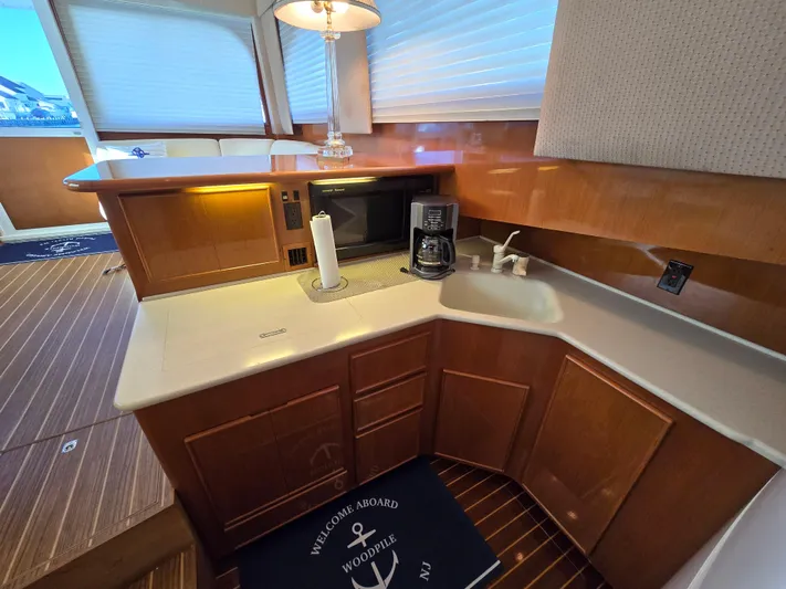  Yacht Photos Pics Kitchen area in a 2000 Post 47 Convertible yacht with wood cabinetry and appliances.