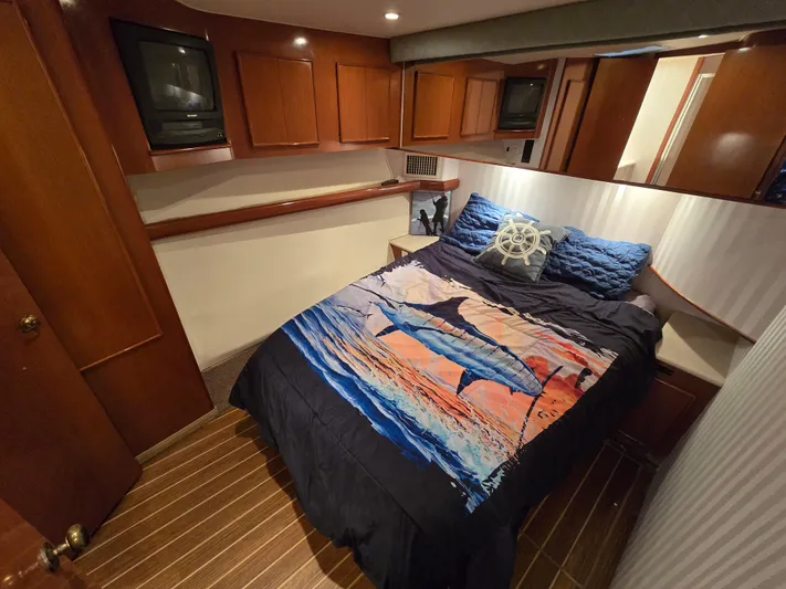  Yacht Photos Pics Luxurious cabin interior of a 2000 Post 47 Convertible yacht with marlin-themed bedding.