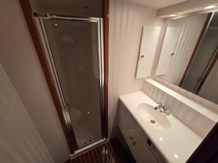  Yacht Photos Pics Compact bathroom in a 2000 Post 47 Convertible yacht with shower and vanity.