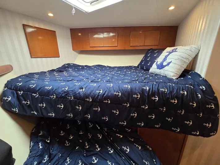  Yacht Photos Pics Cozy cabin bedroom in 2000 Post 47 Convertible yacht with nautical-themed bedding.