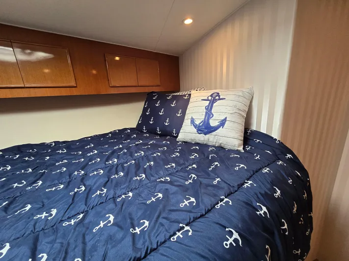  Yacht Photos Pics Nautical-themed bedding in a 2000 Post 47 Convertible cabin, featuring anchor designs.