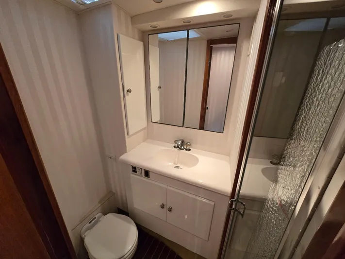  Yacht Photos Pics Bathroom interior of 2000 Post 47 Convertible yacht, featuring sink, mirror, and shower.