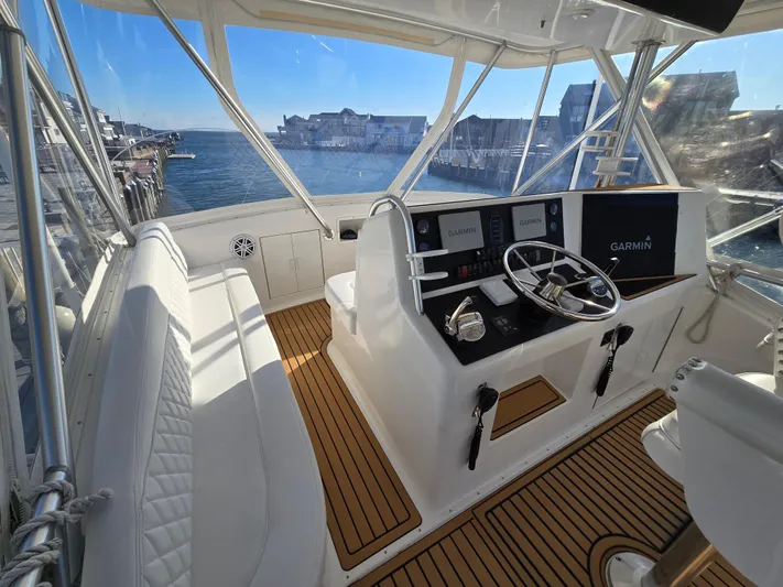 Yacht Photos Pics Helm of 2000 Post 47 Convertible yacht with Garmin navigation, overlooking marina.