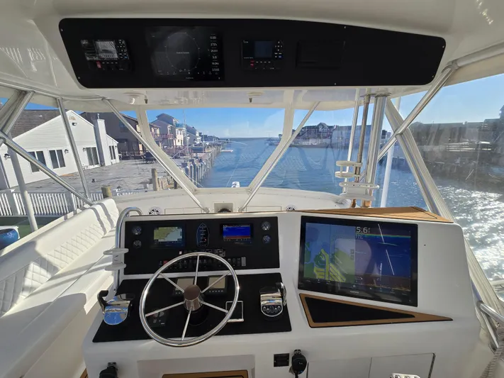  Yacht Photos Pics Helm of 2000 Post 47 Convertible yacht with navigation screens, dockside view.