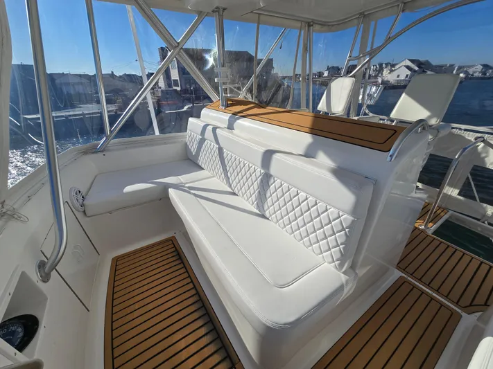  Yacht Photos Pics Luxurious seating area on a 2000 Post 47 Convertible yacht with elegant white upholstery.