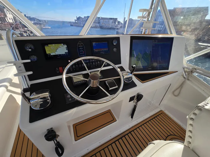  Yacht Photos Pics Helm of 2000 Post 47 Convertible yacht with navigation equipment and scenic harbor view.
