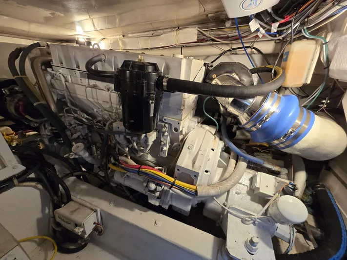  Yacht Photos Pics Engine room of a 2000 Post 47 Convertible boat, showcasing complex machinery and wiring.
