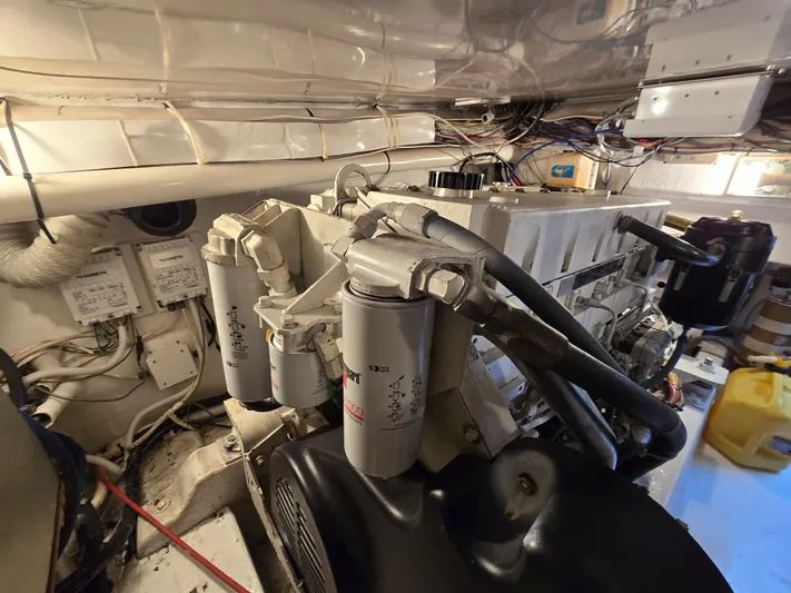  Yacht Photos Pics Engine room of a 2000 Post 47 Convertible yacht, showcasing mechanical components and wiring.