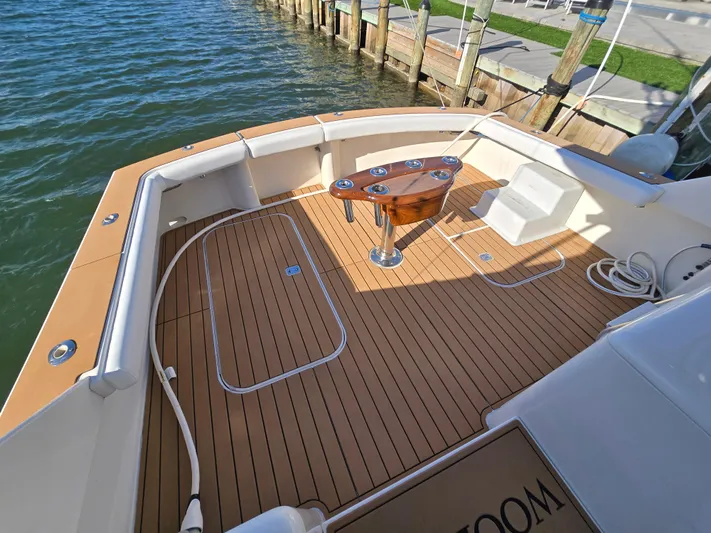  Yacht Photos Pics Deck of a 2000 Post 47 Convertible boat with wooden flooring and fishing chair.
