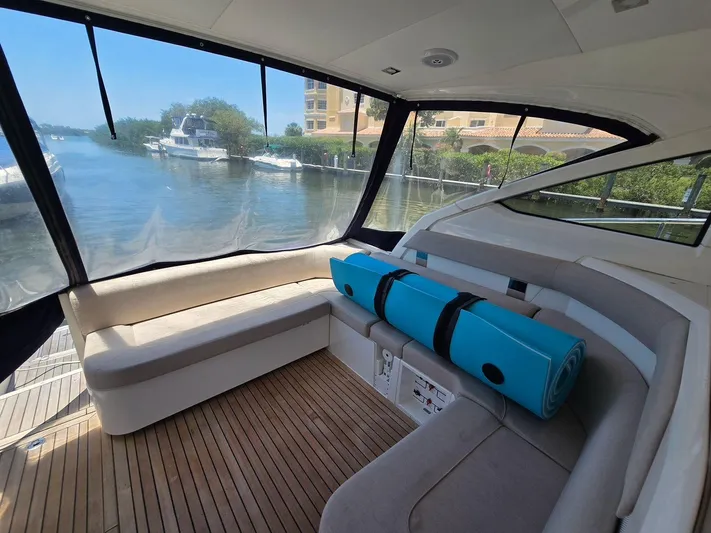  Yacht Photos Pics 2013 Fairline Targa 38 Open yacht interior with seating and rolled mats, docked by the water.