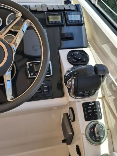  Yacht Photos Pics Control panel of 2013 Fairline Targa 38 Open yacht with steering wheel and navigation controls.