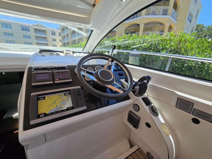  Yacht Photos Pics Cockpit of 2013 Fairline Targa 38 Open yacht with navigation equipment and steering wheel.