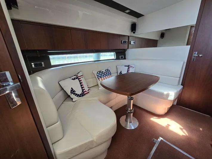  Yacht Photos Pics 2013 Fairline Targa 38 Open interior with white leather seating and nautical-themed cushions.