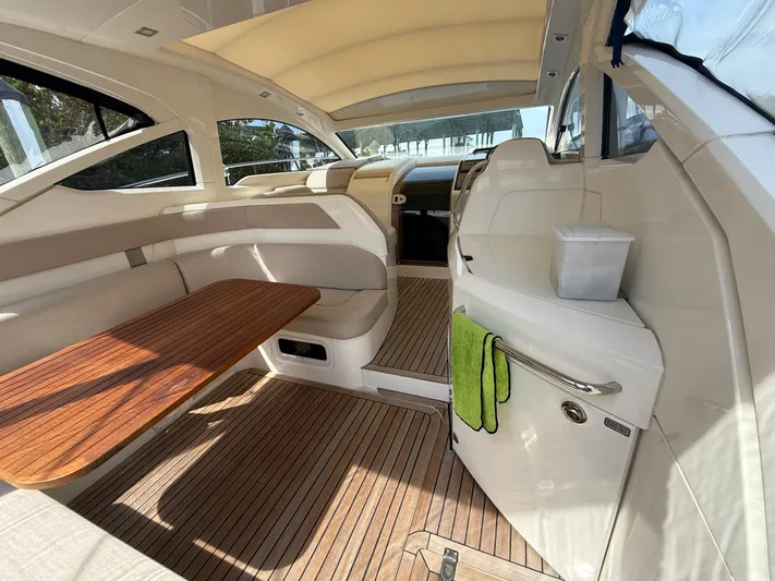  Yacht Photos Pics 2013 Fairline Targa 38 Open yacht interior with wooden table and seating area.
