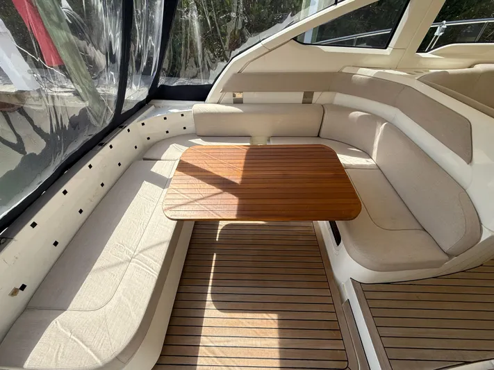 Yacht Photos Pics 2013 Fairline Targa 38 Open yacht interior with wooden table and beige seating.