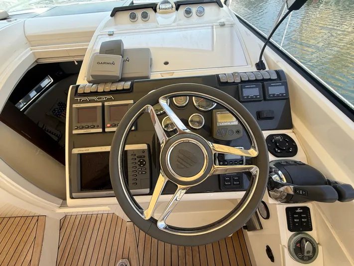  Yacht Photos Pics Cockpit of 2013 Fairline Targa 38 Open with steering wheel and navigation controls.
