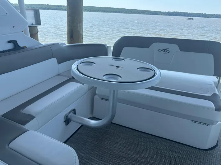 Always Flo&rsquo;n Yacht Photos Pics 2019 Monterey 295 Sport Yacht interior with seating and table, overlooking serene water view.